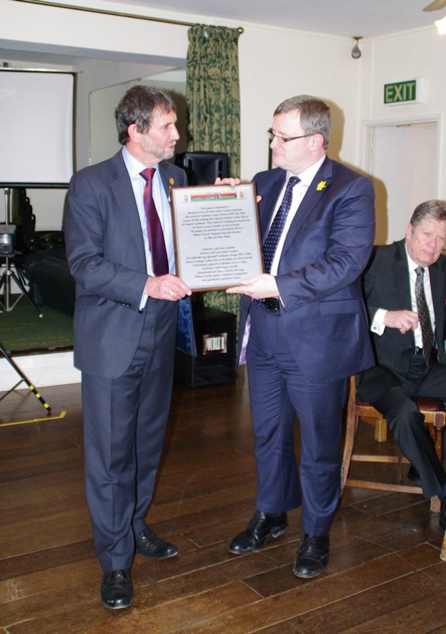 Plaque being handed to William Powell AM